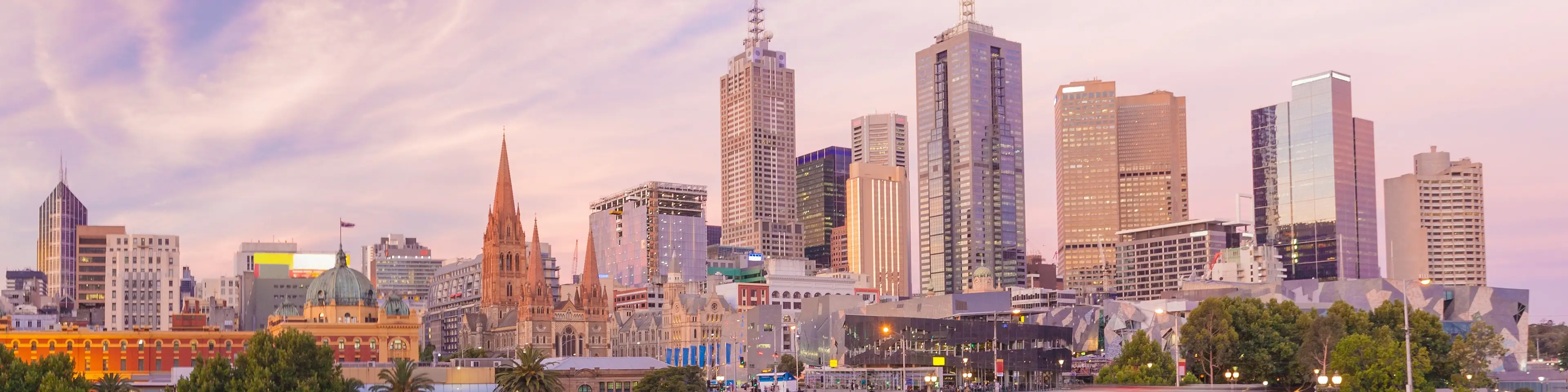 Panoramic sunrise view over Melbourne CBD with historic and modern skyscrapers and Federation Square